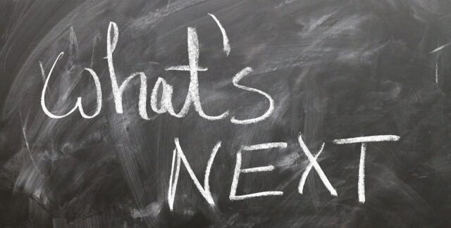 What's Next written in white chalk on gray surface.